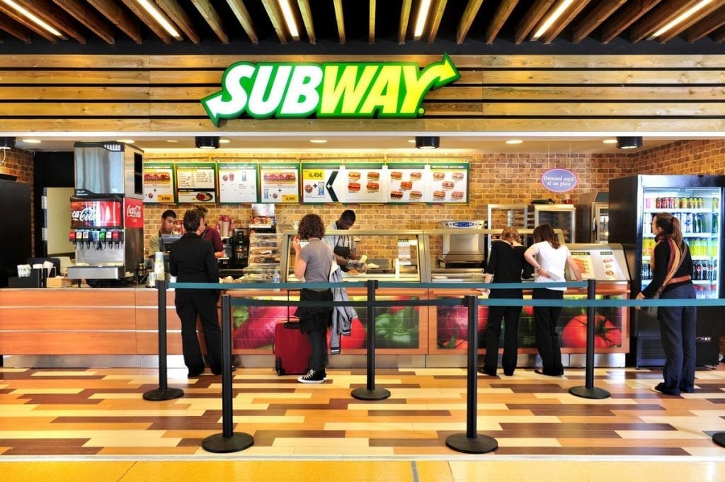 Subway restaurant interior with customers.